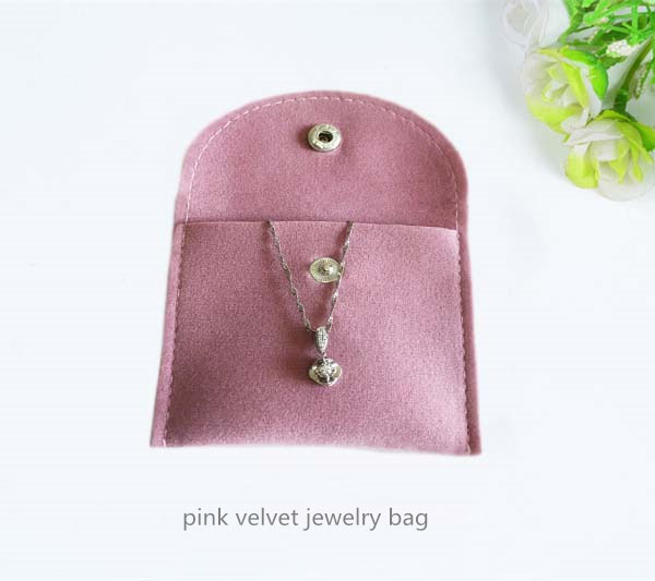 Pink velvet jewelry bag with button closure