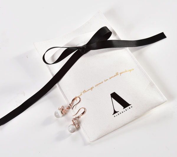 white microfiber jewelry bag with black ribbon